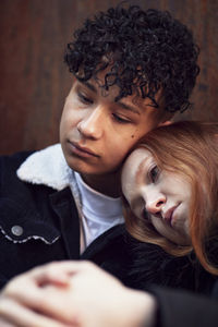 Young woman and boy cuddling and comforting each other