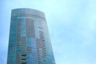 Low angle view of modern building against blue sky