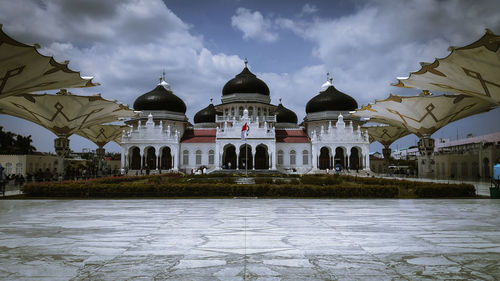 View of buildings against cloudy sky