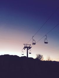 Low angle view of overhead cable car against sky