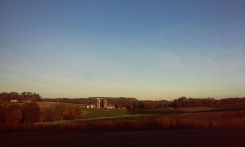 Scenic view of agricultural field against clear sky