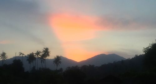 Scenic view of mountains against sky at sunset