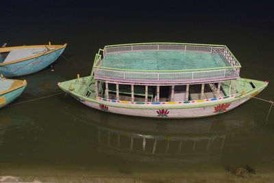 Boats moored in sea against sky