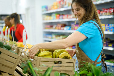Smiling woman working in supermarket