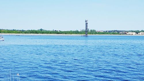 Scenic view of sea against clear blue sky