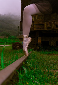 Low section of ballet dancer on railroad track
