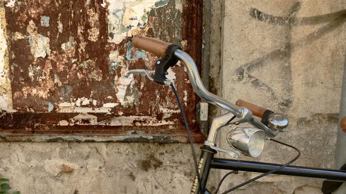 Close-up of old bicycle against wall