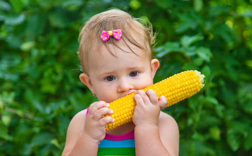 Cute girl eating corn