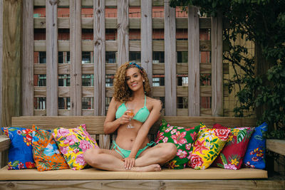 Portrait of smiling young woman sitting outdoors