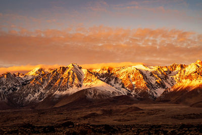Scenic view of snowcapped mountains against sky during sunset