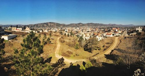 High angle view of town against clear blue sky