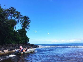 People enjoying in sea against sky
