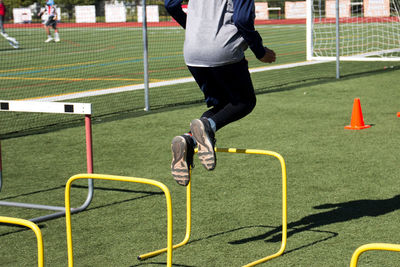 Low section of man playing soccer