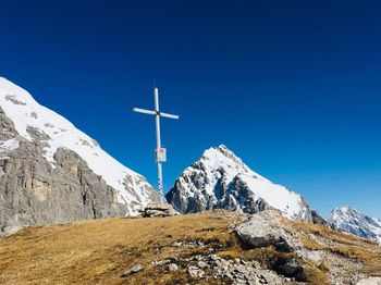 Scenic view of snowcapped mountains against blue sky