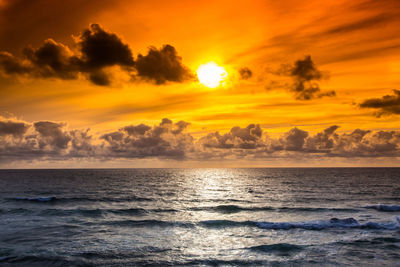 Scenic view of sea against orange sky