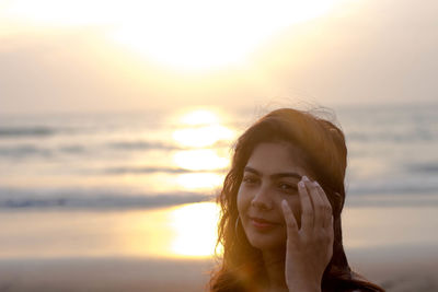 Young woman at beach during sunset