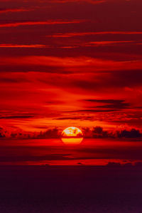 Scenic view of sea against romantic sky at sunset