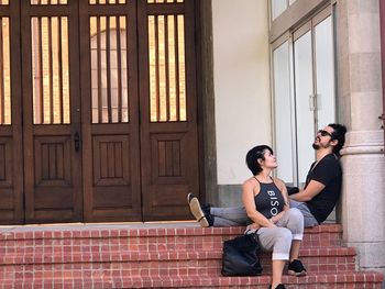 Couple sitting on stairs outdoors