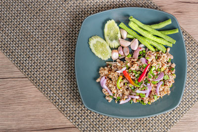 High angle view of chopped fruits in plate on table