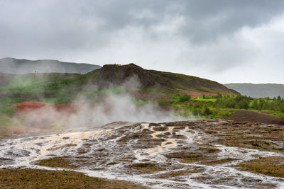 Scenic view of geysir against sky in iceland 