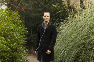 Portrait of smiling young man standing on land