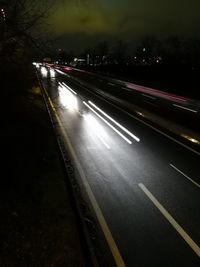 Light trails on road in city at night