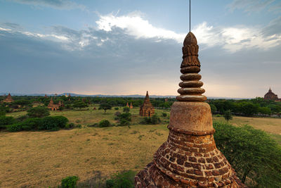 View of temple on field against sky