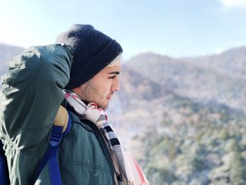 Man looking away against mountains during winter