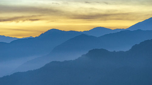 Scenic view of mountains against sky during sunset