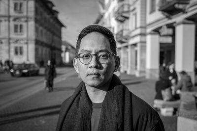 Portrait of man standing on street in city