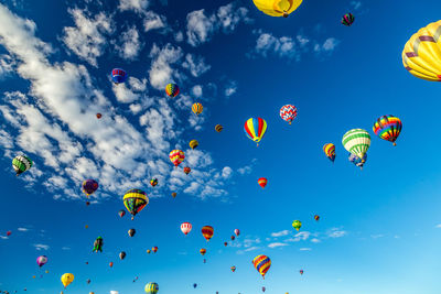 Multi colored hot air balloons flying in sky