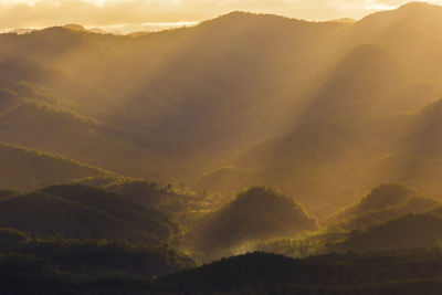 Scenic view of silhouette mountains against dramatic sky
