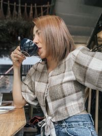 Midsection of woman holding glass