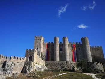 Low angle view of historic building against blue sky