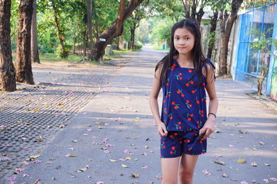 Portrait of young woman standing in park