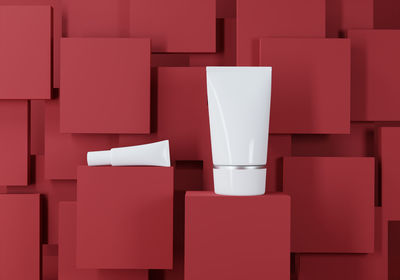 Close-up of moisturizer cream against red cubes