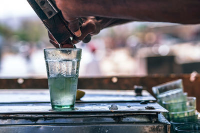 Cropped hands making drink