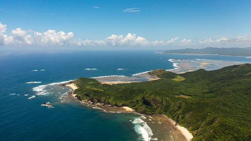 tropical island with jungle and blue sea. cape engano. palaui island. santa ana philippines.