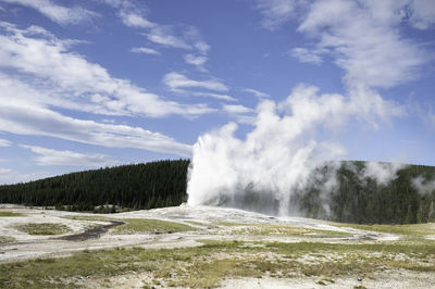 Scenic view of waterfall against sky