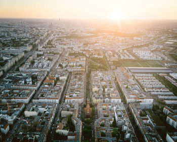 High angle view of city buildings against sky during sunset