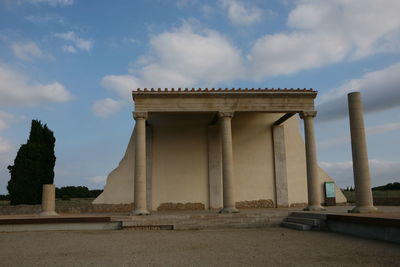 Low angle view of historical building against cloudy sky