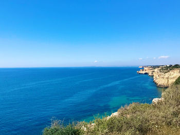Scenic view of sea against blue sky