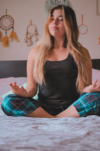 Beautiful young woman sitting at home