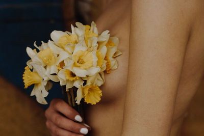 Close-up of hand holding flower bouquet