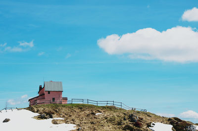 Building by sea against blue sky