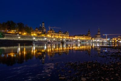 Reflection of illuminated buildings in water at night