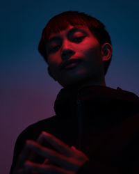 Portrait of young man against gray background