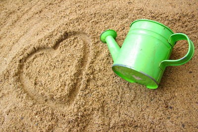 High angle view of human face on sand