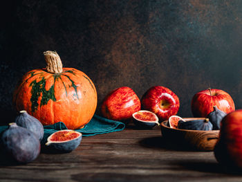 Close-up of pumpkin and fruits on table