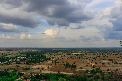 High angle view of field against cloudy sky